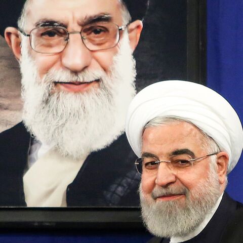 Rouhani with Khamenei portrait behind