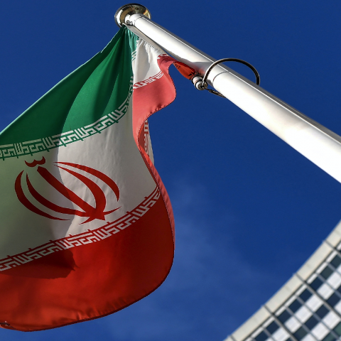 The Iranian national flag is seen outside the International Atomic Energy Agency (IAEA) headquarters during the agency's Board of Governors meeting in Vienna on March 1, 2021. (Photo by JOE KLAMAR / AFP) 