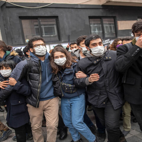 Protesters move away as Turkish police officers intervene during a demonstration in support of Bogazici University students, at Kadikoy in Istanbul, Turkey, April 1, 2021.