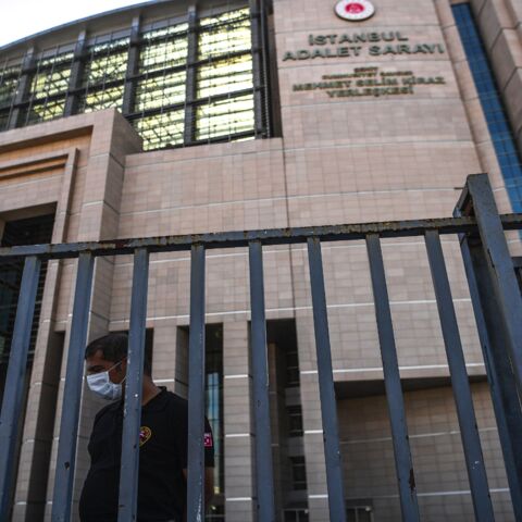 A security guard stands in front of Istanbul's courthouse on July 3, 2020, during the trial of 20 Saudi suspects accused in the murder of journalist Jamal Khashoggi in 2018 in Istanbul. The trial in absentia of 20 Saudi suspects accused of the murder, including two former aides to Saudi Crown Prince Mohammed bin Salman, began in Istanbul on July 3, 2020.