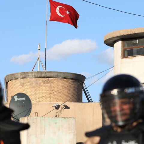 Iraqi riot police protect the Turkish embassy in Baghdad on Feb. 18, 2021 after calls on social media to gather outside the Turkish embassy to protest Turkey's vows to invade the northwestern enclave of Sinjar. 