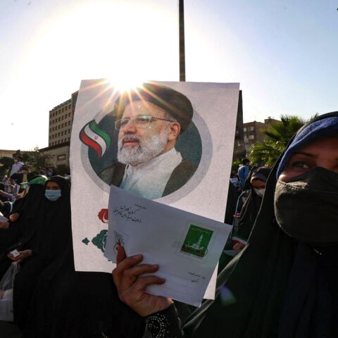 Supporters of Iranian ultraconservative presidential candidate Ebrahim Raisi carry a poster bearing his picture as they attend a rally in the capital, Tehran, on June 16, 2021, ahead of the Islamic Republic's June 18 presidential election. 
