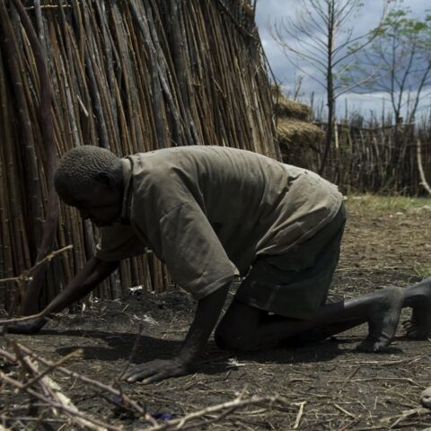 Lochaun John, who suffers from severe undernourishment, crawls into his hut in Lokupoi village, Moroto, Uganda, on March 28, 2008.  