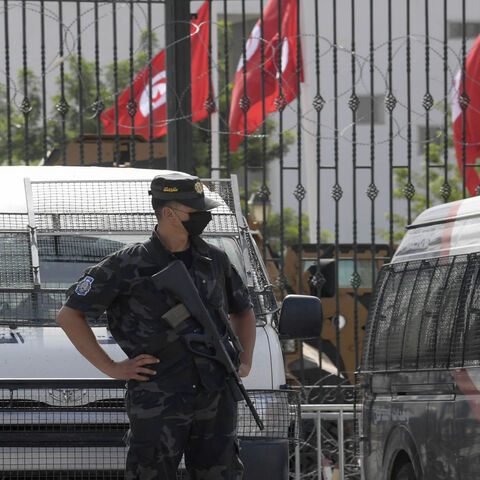 Tunisian police stand guard outside the parliament, Tunis, Tunisia, July 27, 2021.