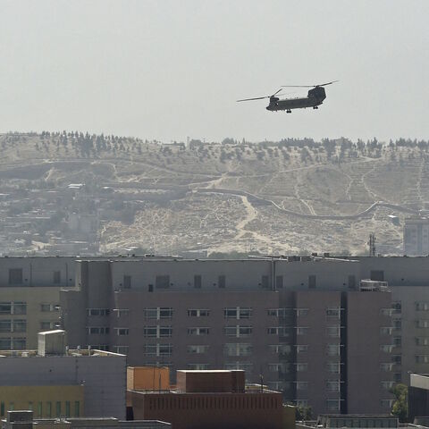 A US Chinook military helicopter flies above the US embassy in Kabul on Aug. 15, 2021.