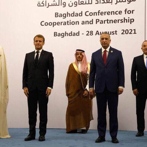 (L to R) Qatars Emir Sheikh Tamim al-Thani, French President Emmanuel Macron, Saudi Foreign Minister Faisal bin Farhan, Iraq's Prime Minister Mustafa al-Kadhemi, Turkey's Foreign Minister Mevlut Cavusoglu, and Jordan's King Abdullah II pose for a group picture after the meeting in Baghdad on Aug. 28, 2021. 