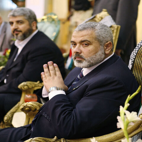 Palestinian Prime Minister Ismail Haniyeh (R) and Hamas leader Khaled Meshaal (C) are seen during a meeting with Palestinian residents in Jeddah, Saudi Arabia, Feb. 10, 2007.