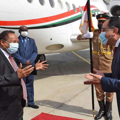Egyptian Prime Minister Mustafa Madbouly (R) welcomes his Sudanese counterpart Abdalla Hamdok upon his arrival in Cairo, Egypt, March 11, 2021.