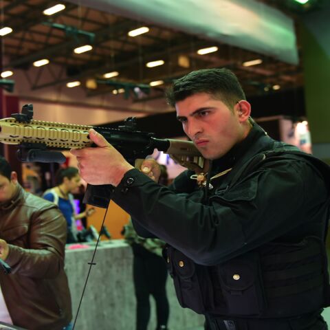 People look at military weapons on May 9, 2017, during the opening day of the 13th International Defense Industry Fair in Istanbul. 