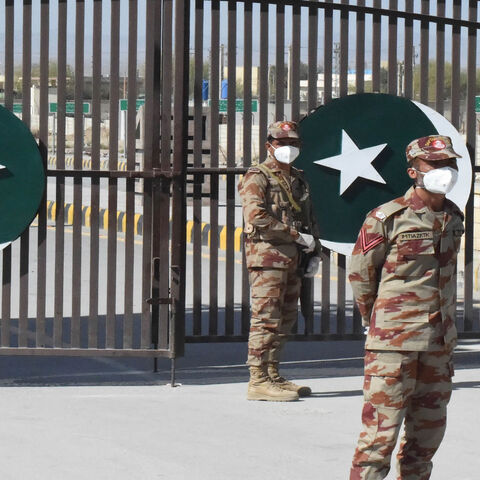 Pakistani soldiers wear facemasks on the closed border of Pakistan-Iran in Taftan, as fears over the spread of the coronavirus escalate following an outbreak in neighboring Iran, Pakistan, Feb. 25, 2020.
