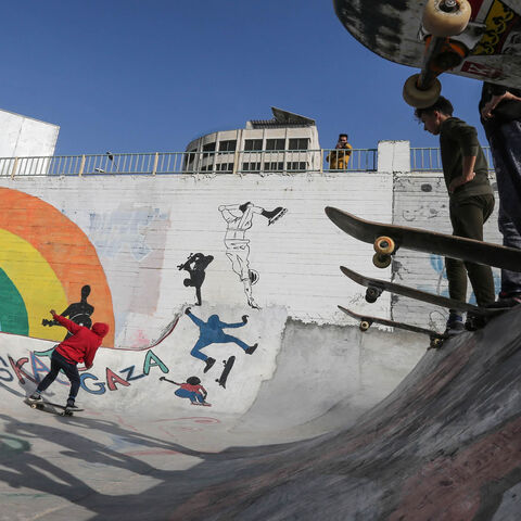 Palestinian youths ride their skateboards near the sea port of Gaza City, Gaza Strip, March 20, 2019.