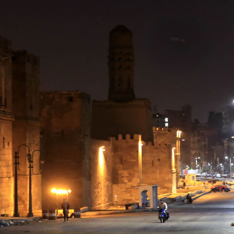 The street along the carved minaret of Al-Hakim Mosque is deserted on the first day of a two-week night-time curfew imposed by the authorities to contain the spread of the coronavirus, Cairo, Egypt, March 25, 2020.