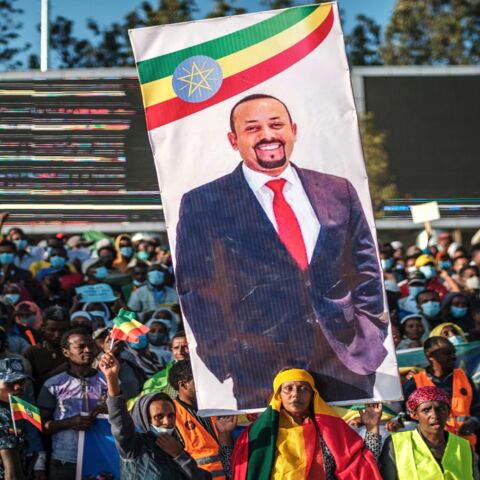 A woman holds a banner with the portrait of Primer Minister Abiy Ahmed during a rally in Addis Ababa, Ethiopia, on Nov. 7, 2021.