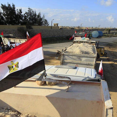 An Egyptian truck loaded with gravel enters through the Rafah border crossing, between Egypt and the Gaza Strip, as building material for the Qatari grant projects begin arriving, in the southern Gaza Strip, Dec. 29, 2012.