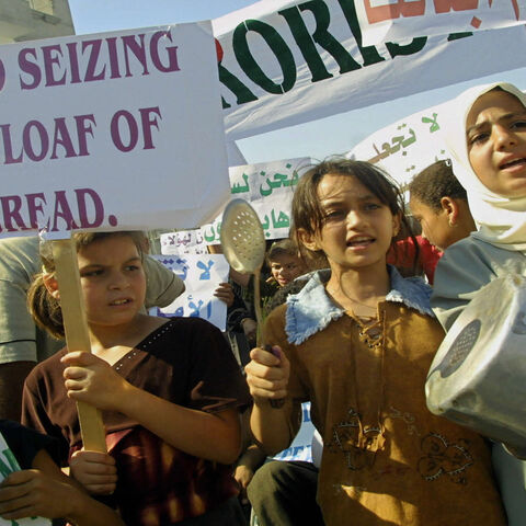 Palestinian children demonstrate against the Palestinian Authority's decision to freeze some bank accounts linked to Islamic organizations, Rafah refugee camp, Gaza Strip, Aug. 28, 2003.