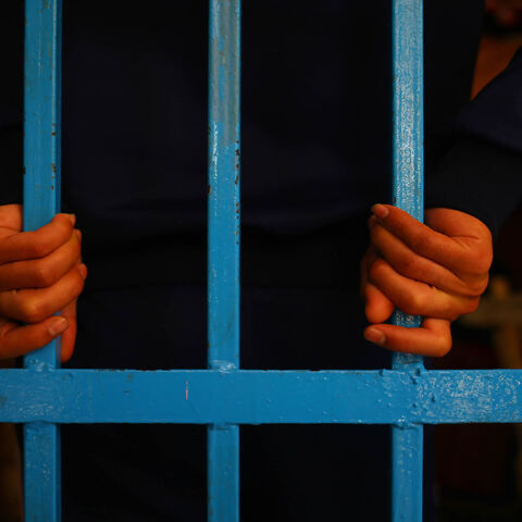 A drug addict stands behind bars at a Hamas-run prison in Gaza City, Gaza Strip, May 10, 2017.