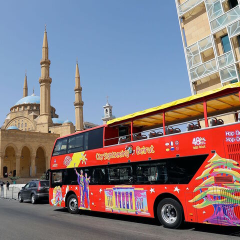 A city sightseeing bus is pictured parked outside Beirut's landmark Mohammad al-Amin mosque on May 20, 2019. 