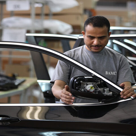 An Egyptian worker assembles car doors at a BMW factory, 6th of October City, Egypt, May 29, 2011.
