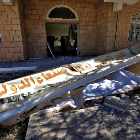Airport workers inspect the damage at Sanaa International Airport on Dec. 21, 2021, following a reported airstrike by the Saudi-led coalition.