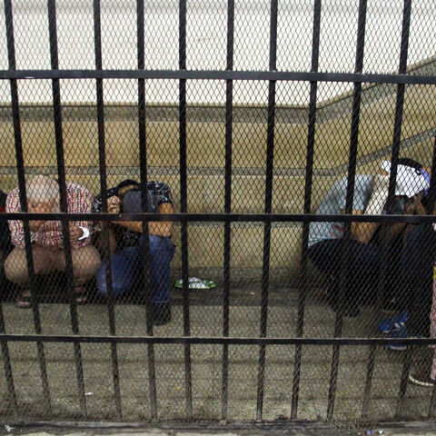 Eight Egyptian men on trial for doing a video prosecutors claimed was of a gay wedding hide their identities as they sit in the defendant's cage during their trial, Cairo, Egypt, Nov. 1, 2014.