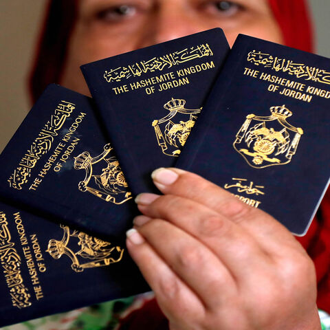 A Palestinian woman shows Jordanian passports in the Palestinian neighborhood of Beit Hanina in East Jerusalem, Aug. 5, 2019.