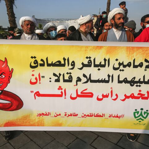 Shiite Muslim clerics march with a banner saying that alcohol is the root of all sin, during a demonstration in Baghdad on Dec. 3, 2020.