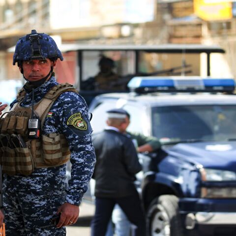 Members of the Iraqi federal police force stand guard at a checkpoint in Baghdad, on January 29, 2021.