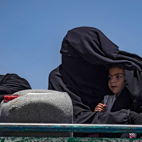 Syrian families sit in a truck after being released from the Kurdish-run al-Hol camp, which holds relatives of suspected Islamic State fighters, Hasakah governorate, Syria, June 2, 2021.