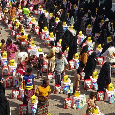 Those displaced by conflict receive food aid in the Tuhayta district of Yemen's war-ravaged Hodeidah province, on June 30, 2021.