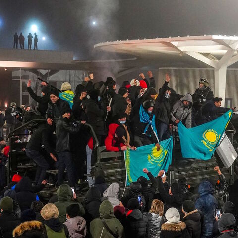 Protesters take part in a rally over a hike in energy prices in Almaty on January 5, 2022. 