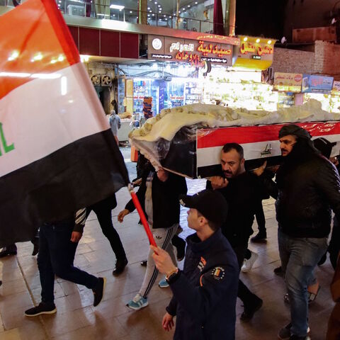 Mourners carry the casket of one of eleven Iraqi soldiers, killed in an overnight attack by the Islamic State (IS) group against a base in eastern Iraq, through a street in the central holy shrine city of Najaf, on Jan. 21, 2022.