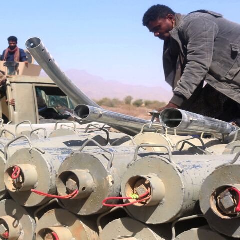 Yemeni pro-government fighters surround ordnances removed from the district of Harib on Jan. 25, 2022.