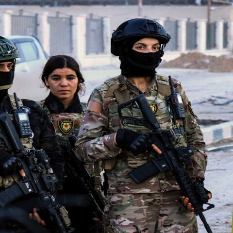 Female members of the Syrian Democratic Forces deploy outside Ghwayran prison in Syria's northeastern city of Hasakeh on January 26, 2022.