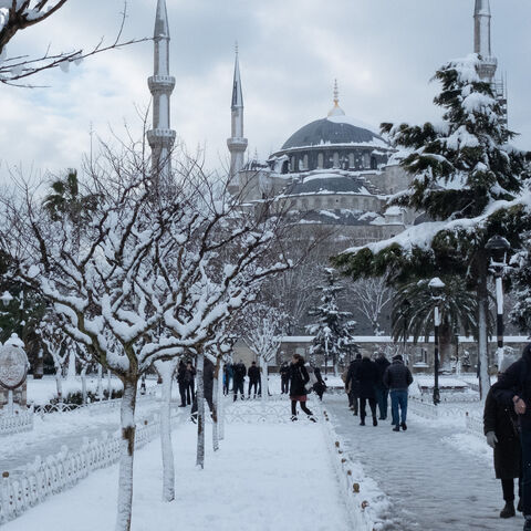 People walk through snow in front of the Blue Mosque in the Sultanahmet District on Jan. 25, 2022 in Istanbul, Turkey. 