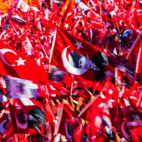People wave Turkish flags and portraits of modern Turkey's founding father, Mustafa Kemal Ataturk, during a rally organized by main opposition group the Republican People's Party, on July 24, 2016, in Istanbul's Taksim Square. 