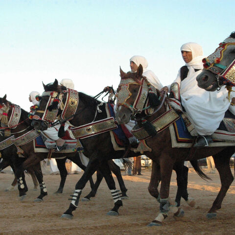 Libyan men in traditional outfits arrive on their horses during a group wedding ceremony held in the western port city of Misurata, Libya, Sept. 5, 2006.