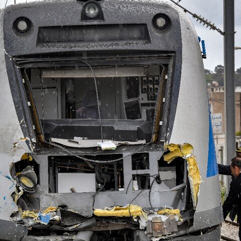Police inspect the damage to one of the locomotives in a train collision in the Jbel Jelloud area in the south of Tunisia's capital Tunis on March 21, 2022