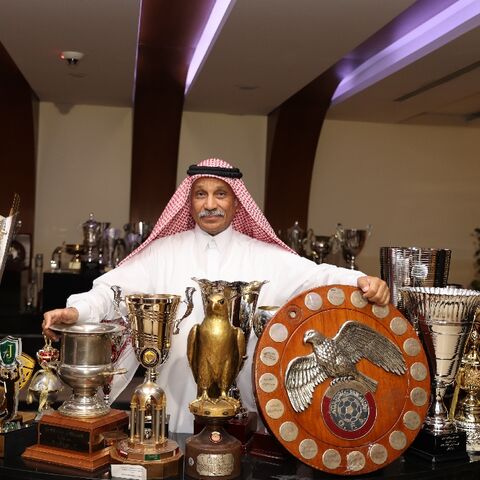 Hassan Mattar a former Al-Sadd striker who now works for the club, poses  with its trophies - before the team clinched its latest league title