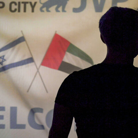 A member of an Israeli tech delegation uses his phone in a video call during an evening meeting with Emirati counterparts at a hotel in Dubai, United Arab Emirates, Oct. 25, 2020.