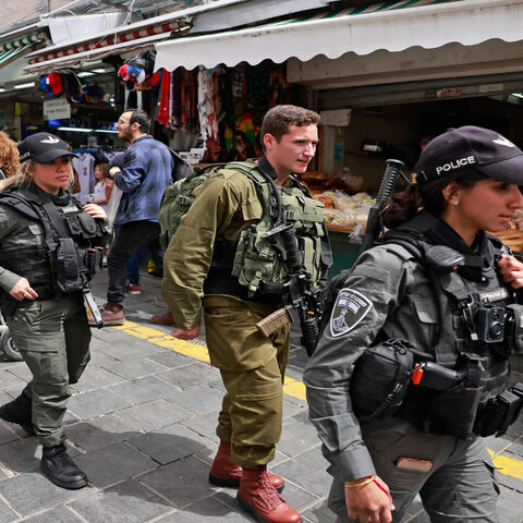 Israeli security forces patrol Jerusalem's Mahane Yehuda market, a day after a Palestinian gunman killed two Israeli men and wounded several others in Tel Aviv, April 8, 2022.