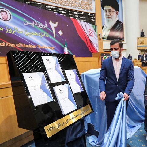 Iran's President Ebrahim Raisi (R) witnesses unveiling of the "Nuclear Industry Strategic Document" for the next two decades at an event during the 16th "National Day of Nuclear Technology" in Tehran on April 9, 2022