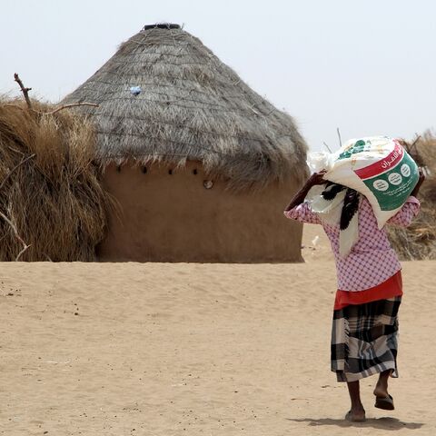 The Yemen war has displaced millions, including this resident receiving food aid at a camp in Hodeida province