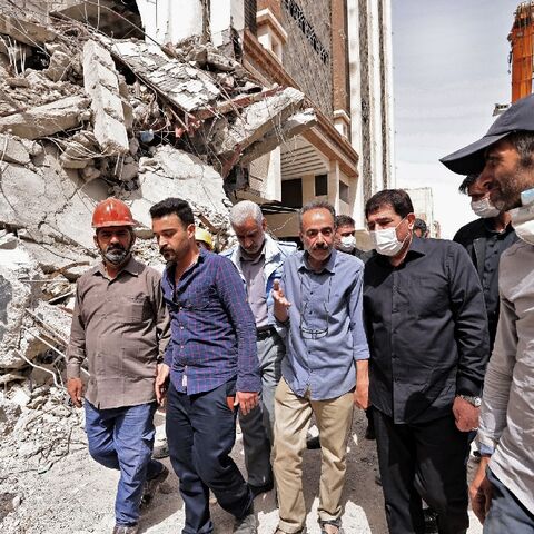 Iranian Vice President Mohammad Mokhber (2nd-R), shown visiting the site of the collapsed building, said there had been "widespread corruption"