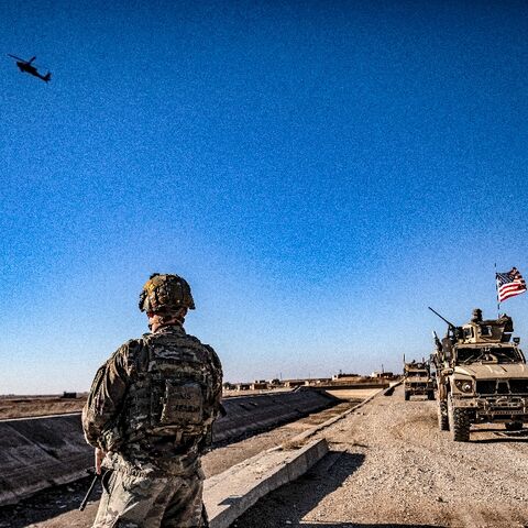 US soldiers patrol between areas held by the Syrian Kurdish forces and Turkish-backed fighters in northeastern Syria in December 2021