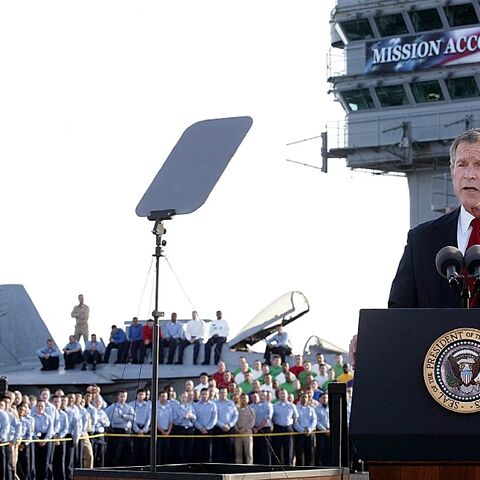 US President George W. Bush addresses his nation aboard the aircraft carrier USS Abraham Lincoln in the Gulf on May 1, 2003, in front of a banner reading "Mission Accomplished" --  a claim belied by years more of hard fighting in Iraq