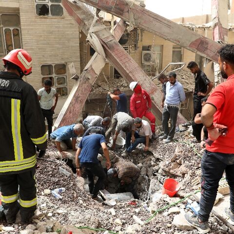Iranian rescuers search the rubble of a 10-storey building that collapsed in the southwestern city of Abadan 