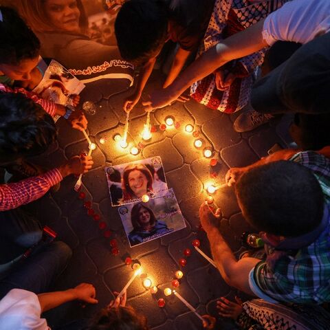 Palestinians light candles during a vigil in honour of Al-Jazeera journalist Shireen Abu Akleh in Gaza City on May 26, 2022