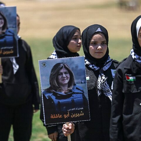 Palestinian youths hold a mock funeral for slain Al Jazeera reporter Shireen Abu Akleh in Gaza City on May 17, 2022