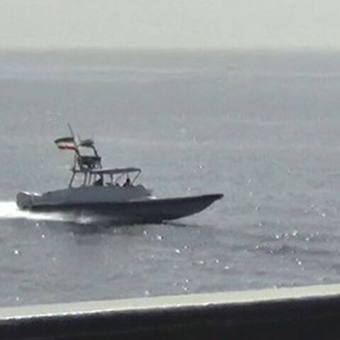 A photo released on June 20, 2022 by the US Defense Visual Information Distribution Service shows a boat of Iran's Islamic Revolutionary Guard Corps Navy in close proximity to patrol coastal ship USS Sirocco 