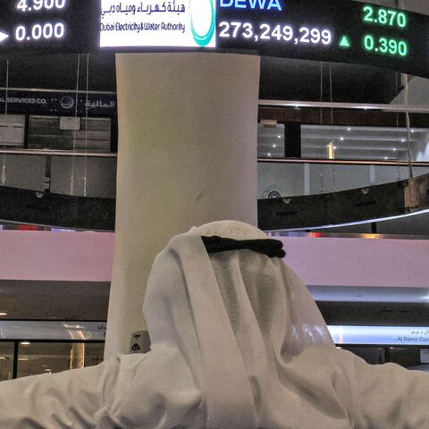 A man watches stock movements on a display at the Dubai Financial Market stock exchange in the Gulf emirate on April 12, 2022. - Shares in the Dubai Electricity and Water Authority (DEWA) rose 16 percent on April 12 in the Gulf region's biggest initial public offering since Saudi oil giant Aramco in 2019. (Photo by Giuseppe CACACE / AFP) (Photo by GIUSEPPE CACACE/AFP via Getty Images)